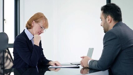 Woman HR specialist manager talking to Indian male job candidate job interview and shake hands after conversation or job interview at office meeting. Recruitment concept