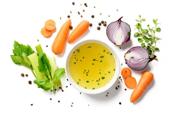 Foto op Plexiglas Chicken broth, stock or bouillon with vegetables isolated on white background. top view © Nelea Reazanteva