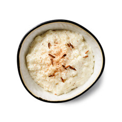 Fresh prepared rice pudding garnished with cinnamon flakes. Healthy breakfast for every day. Isolated on white background. top view
