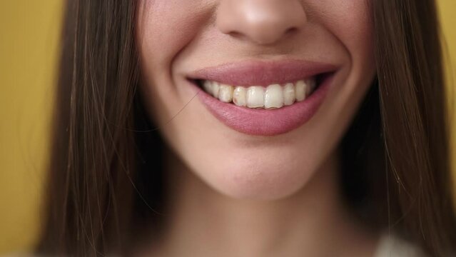 Young beautiful hispanic woman wearing aligner smiling confident over isolated yellow background
