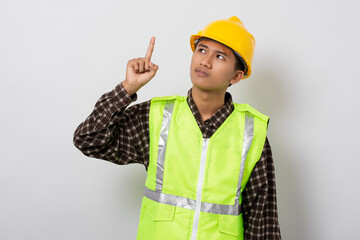 Young asian construction worker thinking and confused making decision isolated on white background