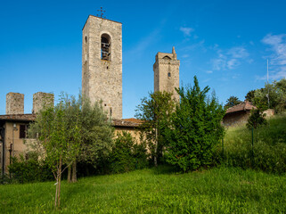 Fototapeta na wymiar Belfry of Collegiata di Santa Maria Assunta Church and Torre Grossa Tower, San Gimignano, Tuscany (Toscana), Italy