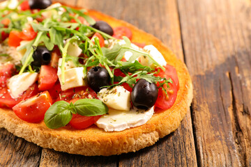italian bruschetta with tomato, olive, cheese and basil