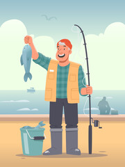Happy fisherman stands against the backdrop of the sea and holds a fish that he has caught with a bait