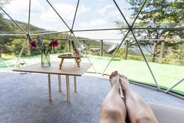 Fototapeta premium a woman enjoys solitude inside of a transparent bubble hotel.