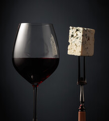 Glass of red wine and blue cheese.