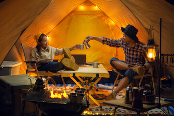 Asian couple enjoy in they tent in camping trip on night time with many star on the sky
