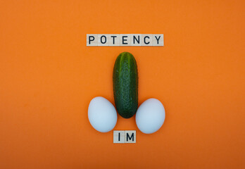 Cucumber and eggs on an orange background. The concept of healthy food, diet and potency.