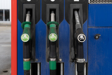 Fuel nozzles with hoses, attached to the gas station column, gasoline pump stand or dispenser...
