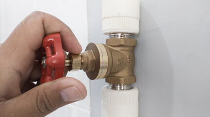 The hand turn brass water valves on pipe line syatem.with shiny light.