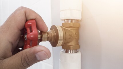 The hand turn brass water valves on pipe line syatem.with shiny light.