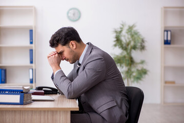 Young male employee working in the office