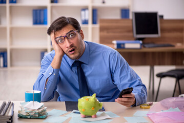 Young male accountant working in the office