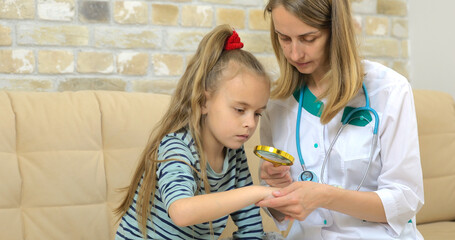 Dermatologist checkup baby girl's hand in the cabinet, close-up view