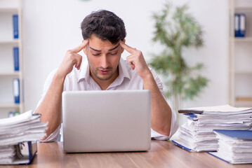 Young male employee working in the office