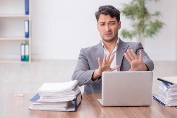 Young male employee working in the office