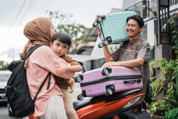 beautiful muslim family going with motorbike together during eid mubarak holiday