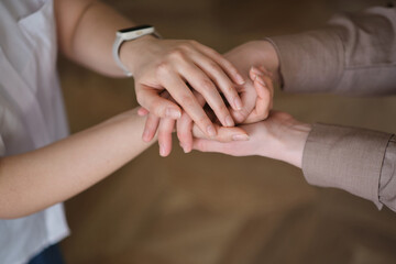 two women holding hands, emphasizing the importance of self-care and emotional well-being. The concept highlights the benefits of relaxation aids and therapeutic activities such as yoga, meditatio