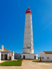 Obraz premium lighthouse Santa Maria of Farol Island at the Algarve coast of Portugal