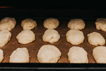 Shaped cookies with sugar sprinkles on a baking sheet. 