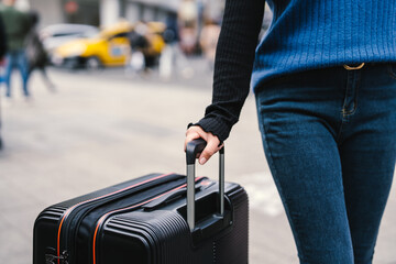 Traveler carrying suitcase luggage at outdoor destination..