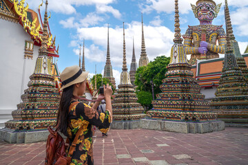 Asian travellert woman walking in Pagoda area in Wat Pho near Thailand grand palace and wat phra kaew - obrazy, fototapety, plakaty