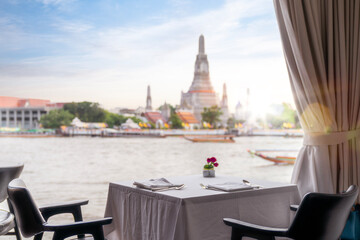 Dinner table in restaurant with Wat arun pagoda and temple back ground