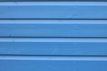 Mid blue panelled wood with peeling paint and space for copy