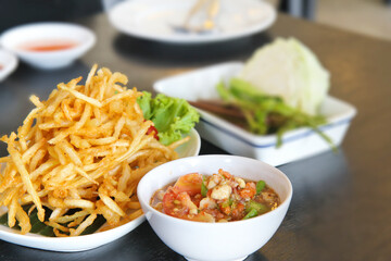 Fried Papaya Salad (Som Tum Tod) Thai Food on the table, served with vegetables, selective focus
