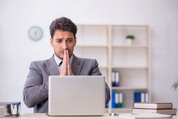 Young male employee working in the office