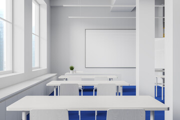 White and blue classroom interior with whiteboard and windows