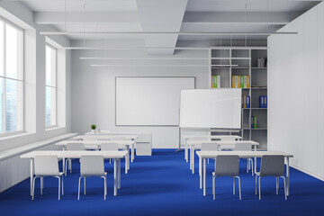 White and blue classroom interior with table in row and chalkboard mockup