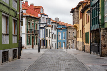 Picturesque alley with colorful houses in the fishing village by the sea, Luanco, Asturias.