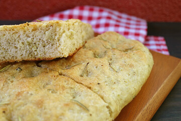 Closeup the Texture of Aromatic Rosemary Focaccia Bread Slices on Wooden Breadboard