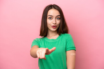 Fototapeta premium Young Ukrainian woman wearing a band aids surprised and pointing front