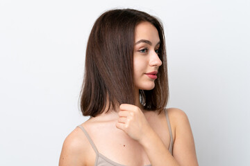 Fototapeta premium Young Ukrainian woman isolated on white background touching her hair. Close up portrait