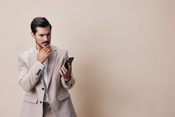 beige man hold portrait suit phone business happy smile smartphone call