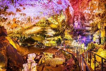 Pathway in Prometheus cave with beautiful colorful structures and formations