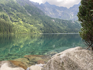 Beautiful alpine lake with clear water and high mountains in the background