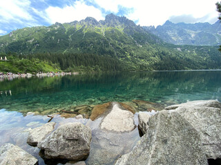 Beautiful alpine lake with clear water and high mountains in the background