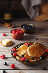 Pancakes with berries in rustic style