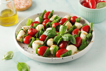 A plate with Italian salad caprese canape	