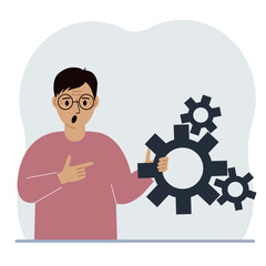 A man holds gears in his hand. Points a finger at the cogwheels. The concept of financial planning, movement, life, education or maintenance.