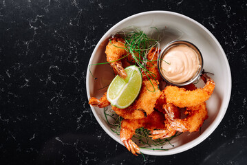 Whole fried big shrimps with seasonings in plate