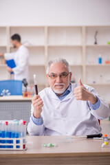 Two male chemists working at the lab