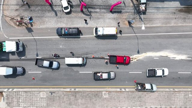Two cars accident on the Road. Top view shot of two crushed cars on the road. Cars go around the scene of an accident. Car Crash Traffic Accident Scene. 