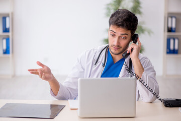 Young male doctor in telemedicine concept