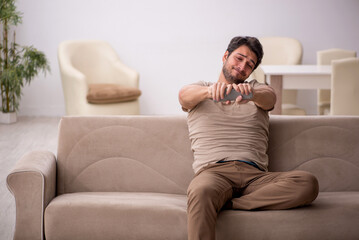 Young man watching tv at home