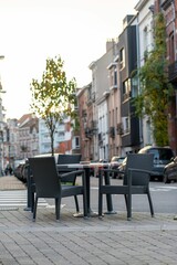 Fototapeta na wymiar Vertical shot of empty chairs on the corner of a street
