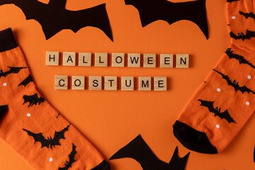 Orange socks with bats. Clothing costume for Halloween costume party. Cheerful bright multicolored...